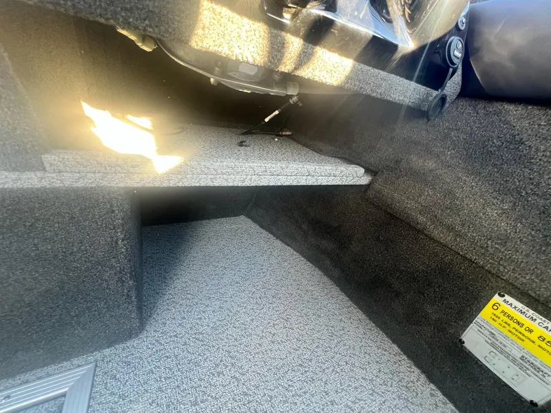 Slide: The Image of Interior view of 2024 Starweld 18 Fusion boat, showcasing carpeted flooring and storage area. - 38
