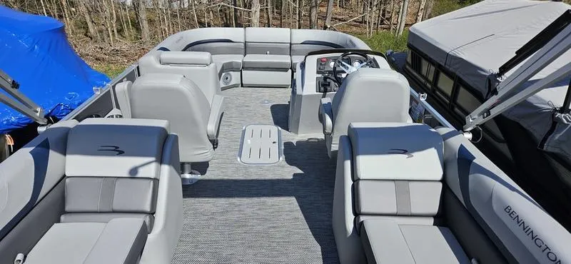 Slide: The Image of 2024 Bennington 22 SXSR pontoon boat interior with gray seating and helm. - 5