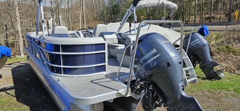 Slide: The Image of 2024 Bennington 22 SXSR pontoon boat with Yamaha outboard engines, parked outdoors. - 6