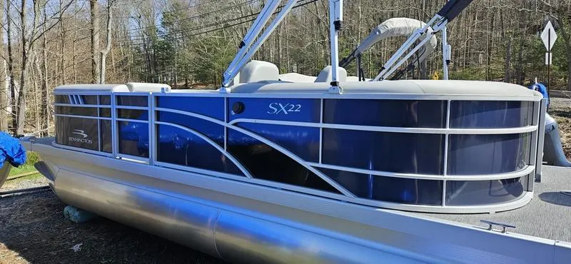 Slide: The Image of 2024 Bennington 22 SXSR pontoon boat in a wooded area. - 7