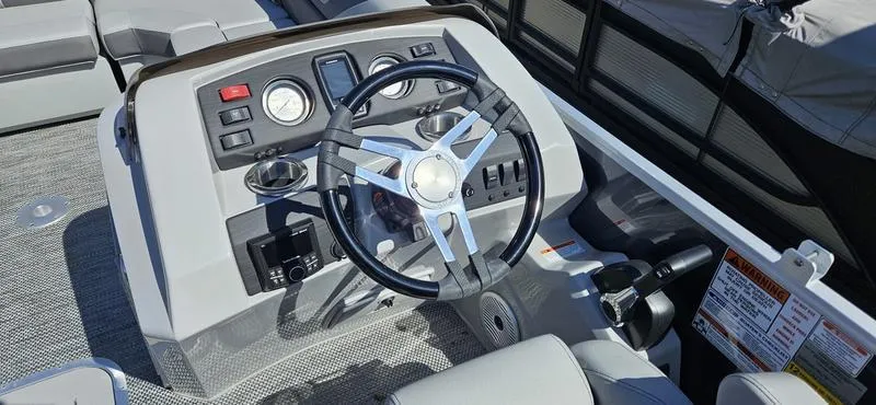 Slide: The Image of 2024 Bennington 22 SXSR boat dashboard with steering wheel and controls. - 9