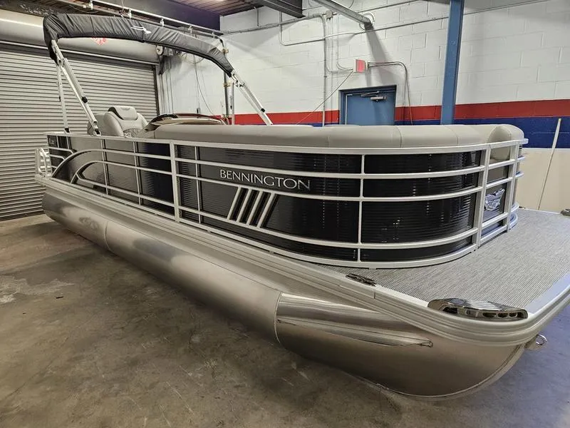 Slide: The Image of 2024 Bennington 22 LSAPG pontoon boat in a showroom. - 0