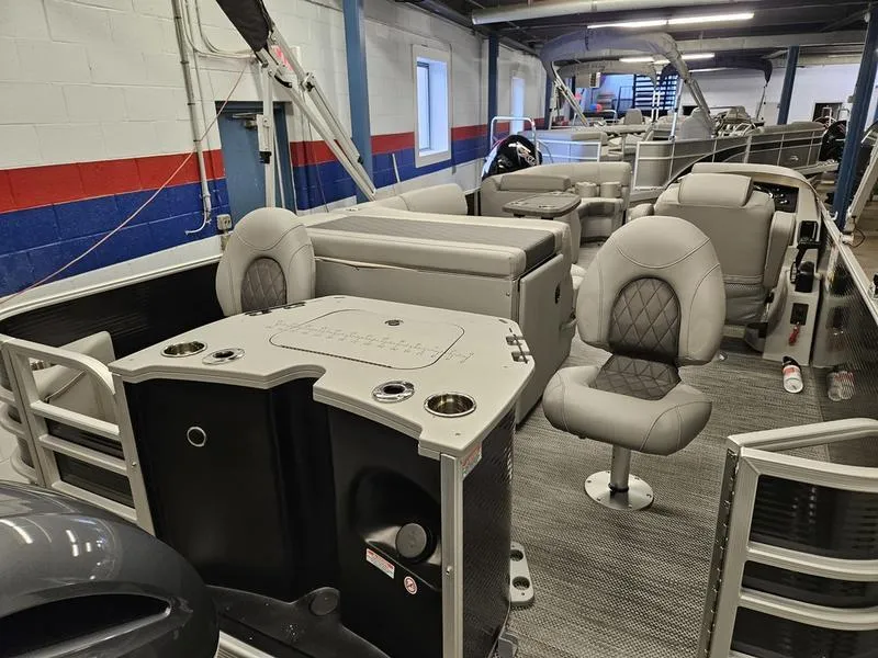Slide: The Image of 2024 Bennington 22 LSAPG pontoon boat interior with seating and control console. - 11