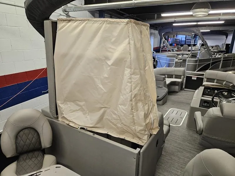 Slide: The Image of 2024 Bennington 22 LSAPG pontoon boat interior with privacy curtain and seating. - 13