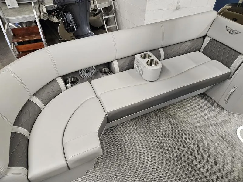 Slide: The Image of 2024 Bennington 22 LSAPG pontoon boat interior with gray seating and cup holders. - 6