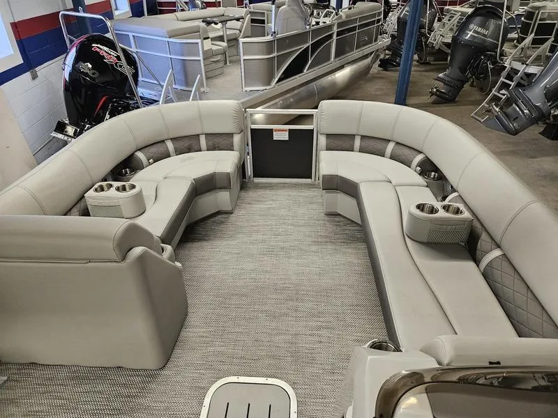 Slide: The Image of 2024 Bennington 22 LSAPG pontoon boat interior with plush seating and cup holders. - 7