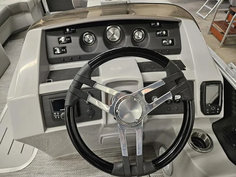 Slide: The Image of 2024 Bennington 22 LSAPG boat dashboard with steering wheel and control panel. - 8