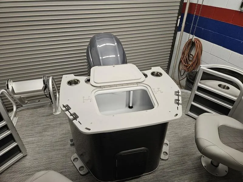 Slide: The Image of 2024 Bennington 22 LSAPG boat interior with motor and seating. - 9