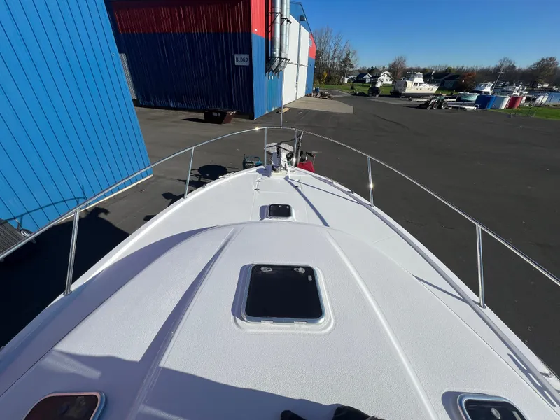 Slide: The Image of 2017 Back Cove Downeast 37 boat docked near blue and red building. - 15