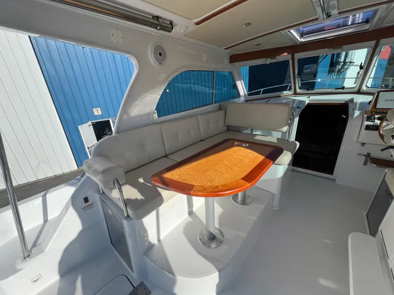 Slide: The Image of Interior of 2017 Back Cove Downeast 37 boat with seating and wooden table. - 24