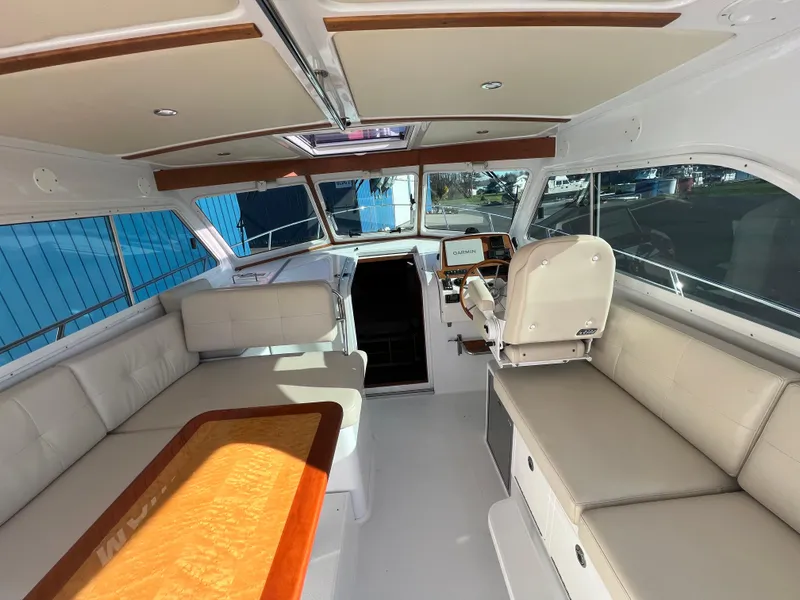 Slide: The Image of 2017 Back Cove Downeast 37 interior with spacious seating and helm station. - 28