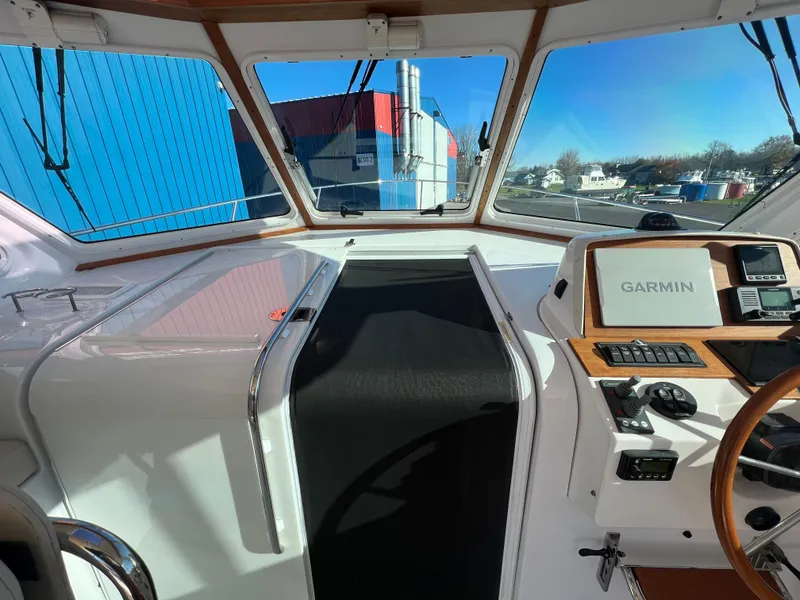 Slide: The Image of 2017 Back Cove Downeast 37 helm with Garmin navigation system and panoramic windows. - 30