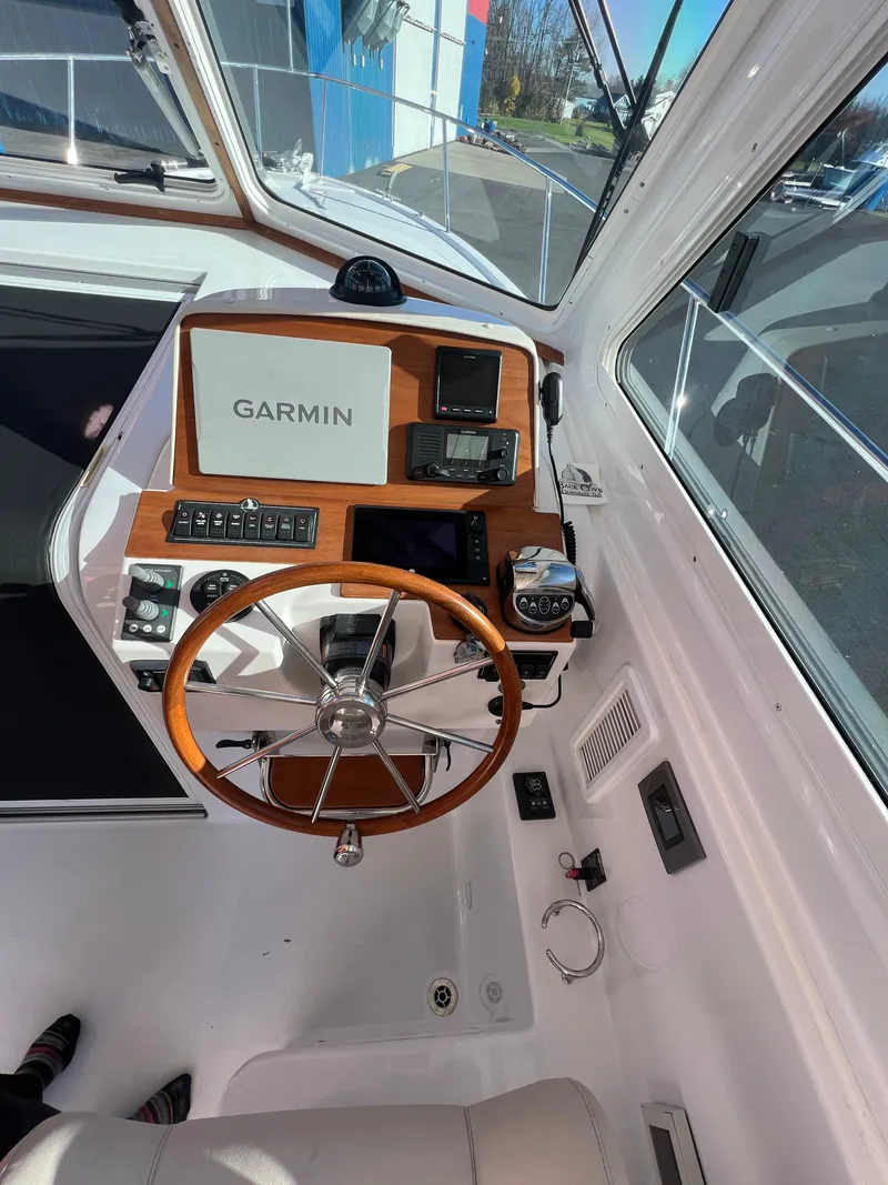 Slide: The Image of 2017 Back Cove Downeast 37 helm with Garmin navigation system and wooden steering wheel. - 33