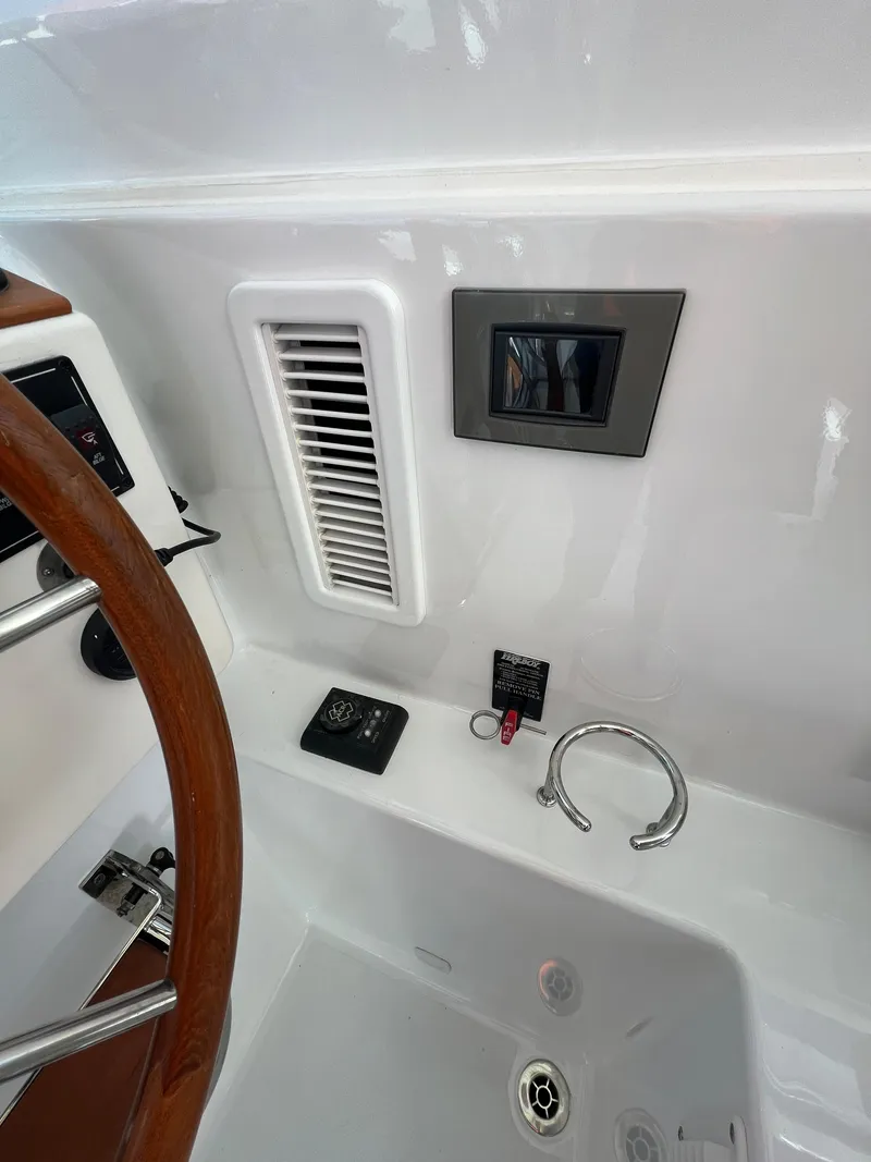 Slide: The Image of 2017 Back Cove Downeast 37 helm station with control panel and ventilation. - 37