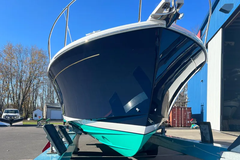 Slide: The Image of 2017 Back Cove Downeast 37 boat on trailer, front view, blue hull, sunny day. - 4