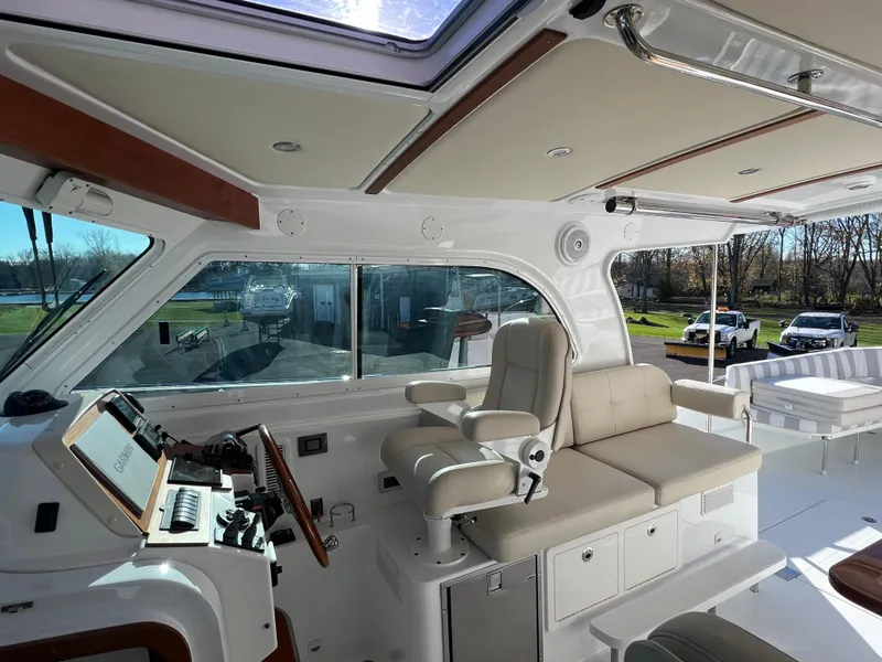 Slide: The Image of 2017 Back Cove Downeast 37 boat interior with helm station and seating area. - 41