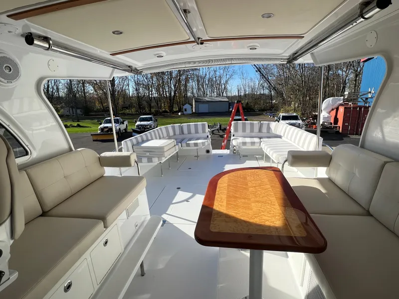Slide: The Image of 2017 Back Cove Downeast 37 boat interior with spacious seating and wooden table. - 42