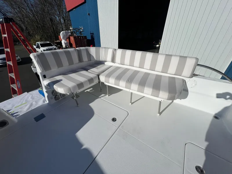 Slide: The Image of 2017 Back Cove Downeast 37 boat with striped seating in the cockpit area. - 45