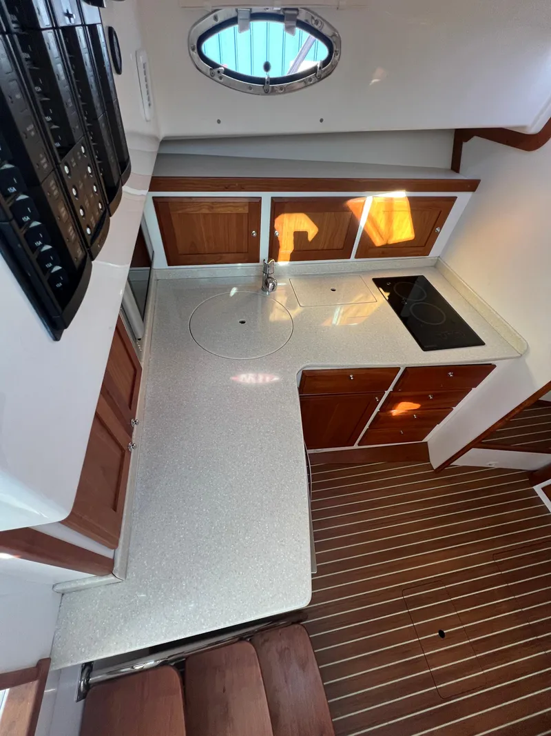 Slide: The Image of 2017 Back Cove Downeast 37 yacht kitchen with modern appliances and wooden cabinetry. - 48