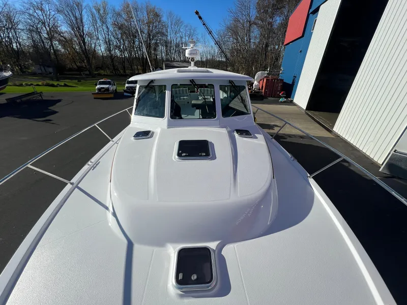 Slide: The Image of 2017 Back Cove Downeast 37 boat docked near a blue and red building. - 13