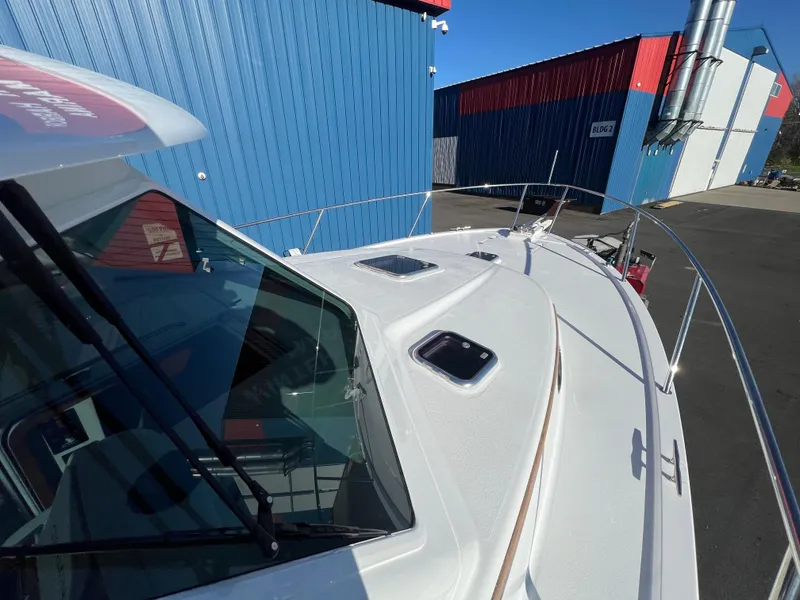 Slide: The Image of 2017 Back Cove Downeast 37 boat docked near blue and red buildings. - 17