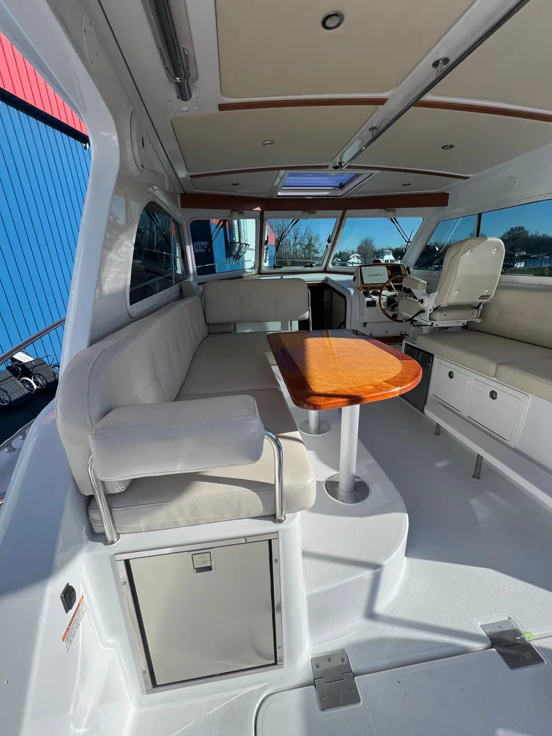 Slide: The Image of 2017 Back Cove Downeast 37 interior with seating and wooden table. - 25