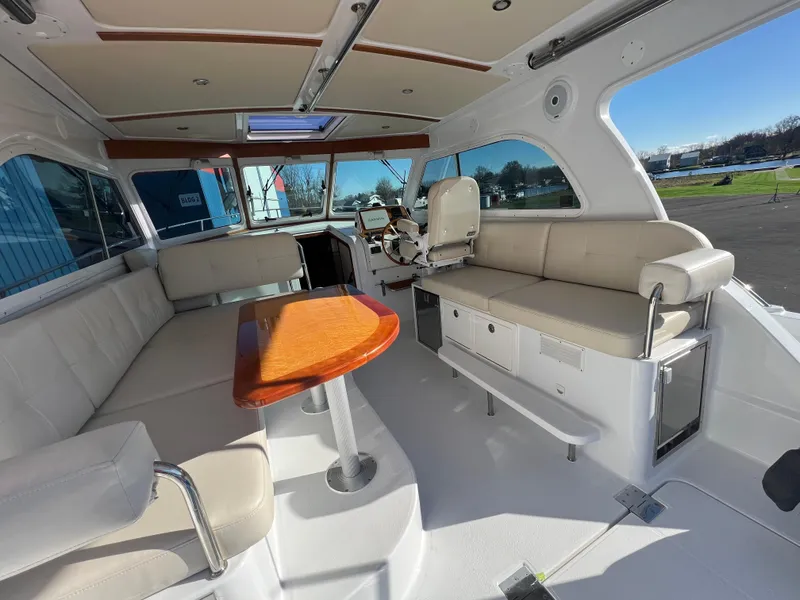 Slide: The Image of Interior of 2017 Back Cove Downeast 37 yacht with seating and wooden table. - 26
