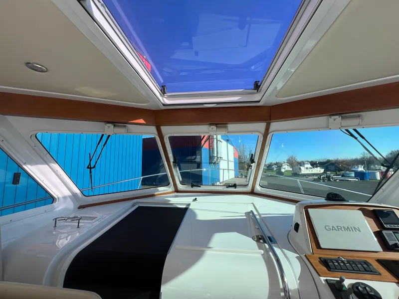 Slide: The Image of 2017 Back Cove Downeast 37 helm with Garmin navigation system and panoramic windows. - 29