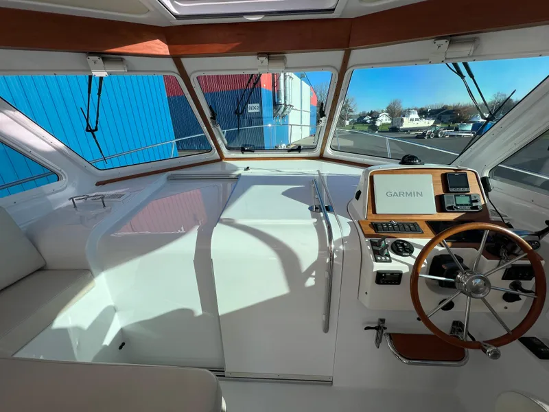 Slide: The Image of 2017 Back Cove Downeast 37 helm with Garmin navigation system and wooden steering wheel. - 31