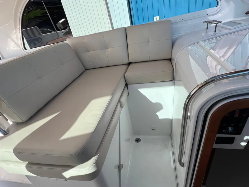 Slide: The Image of 2017 Back Cove Downeast 37 boat interior with cushioned seating area. - 38