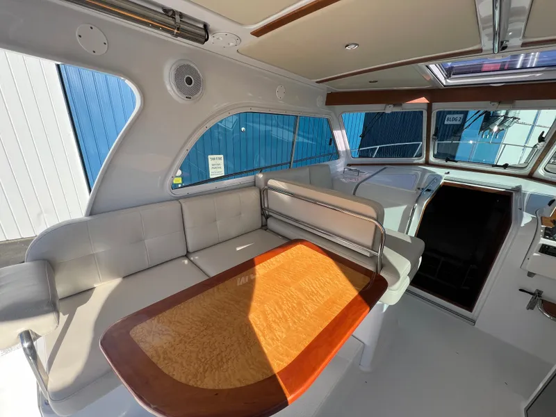 Slide: The Image of 2017 Back Cove Downeast 37 interior with seating and wooden table. - 39