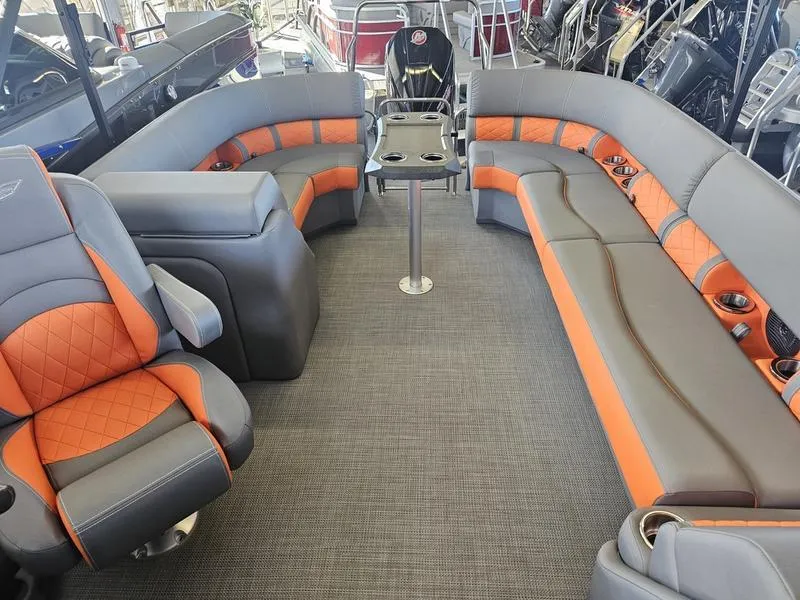 Slide: The Image of 2024 Bennington 24LFBC boat interior with orange and gray seating. - 6
