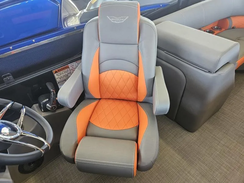 Slide: The Image of 2024 Bennington 24LFBC boat captain's chair with orange and gray upholstery. - 7