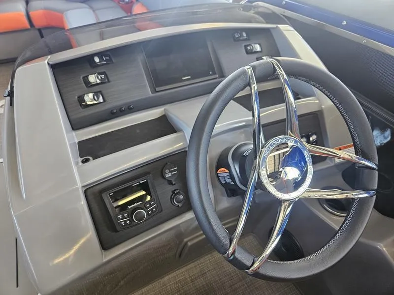 Slide: The Image of 2024 Bennington 24LFBC boat dashboard with steering wheel and control panel. - 8
