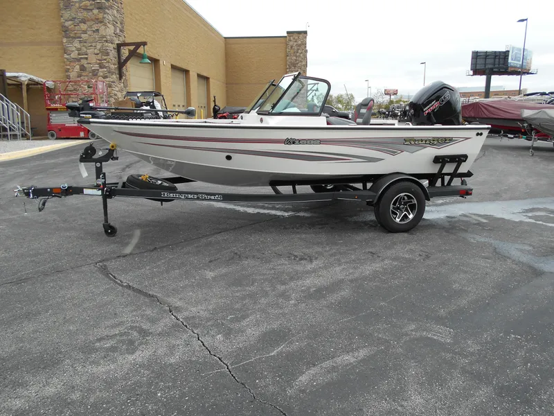 Slide: The Image of 2024 Ranger VS1682SC Angler boat on a trailer in a parking lot. - 2