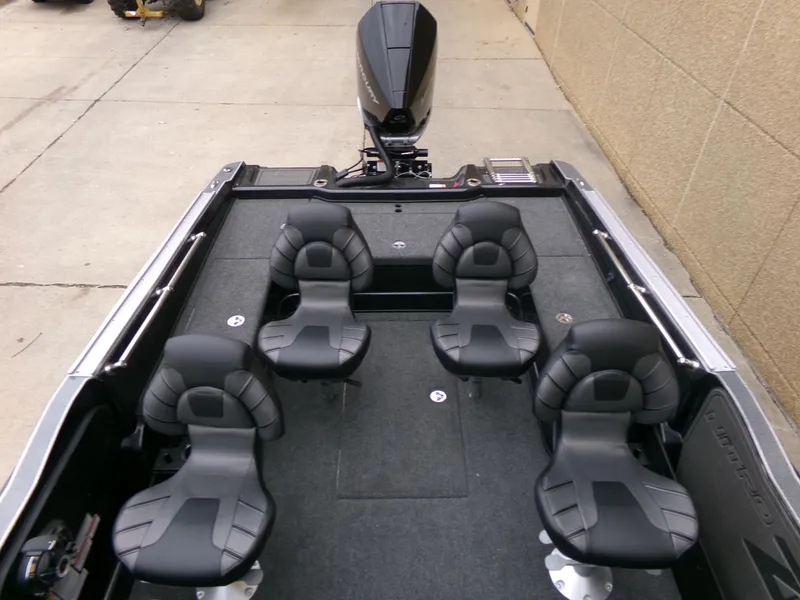 Slide: The Image of 2024 Nitro ZV20 Pro boat interior with four black seats and outboard motor. - 4