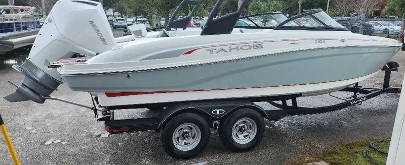 The Image of 2024 Tahoe 210 S boat on a trailer with a Mercury outboard motor. - 0