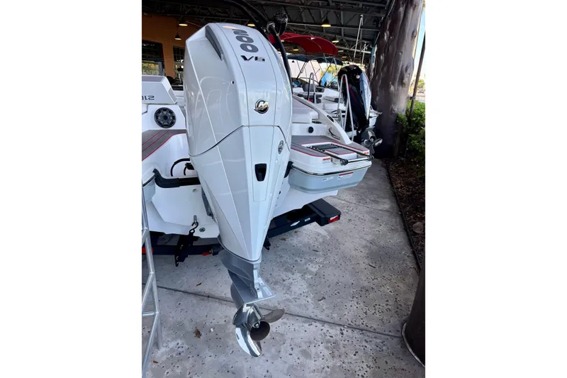 Slide: The Image of 2024 Tahoe 210 S boat with powerful outboard motor in showroom. - 12