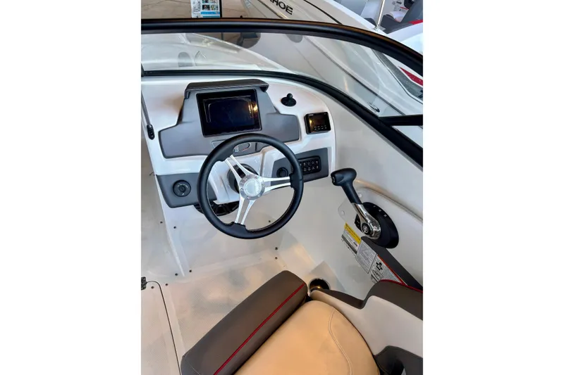 Slide: The Image of 2024 Tahoe 210 S boat cockpit with steering wheel and control panel. - 14