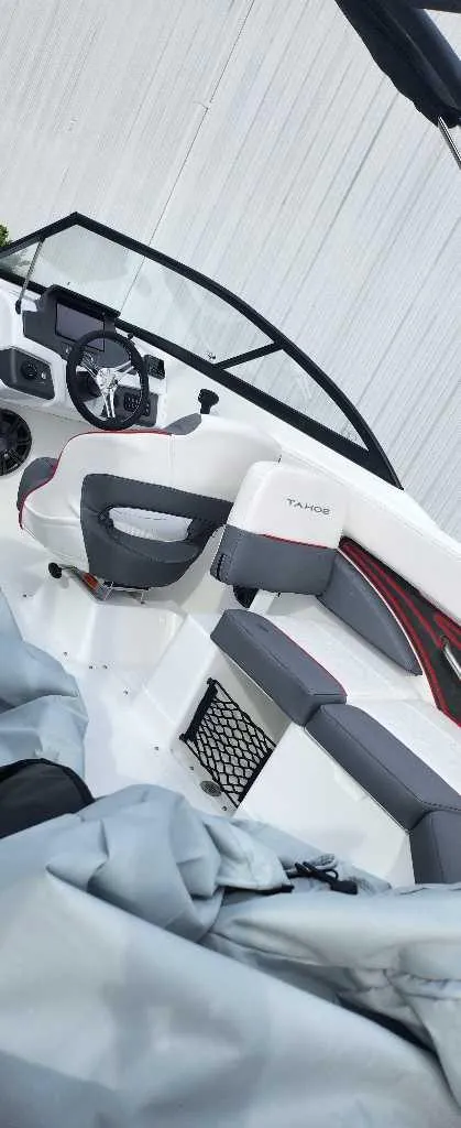 Slide: The Image of 2024 Tahoe 210 S boat interior with modern seating and dashboard. - 4