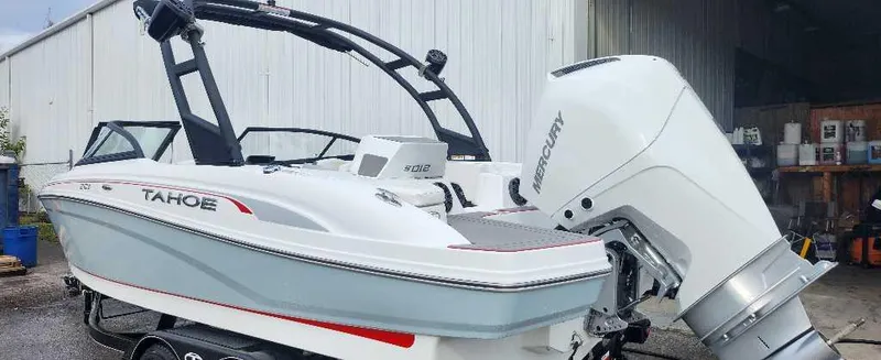 Slide: The Image of 2024 Tahoe 210 S boat with Mercury outboard motor in a storage facility. - 5