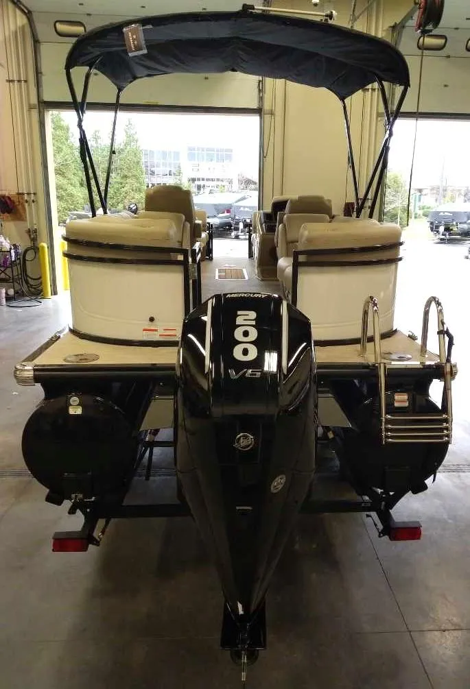 Slide: The Image of 2024 Regency 230 DL3 pontoon boat with 200 HP engine in a showroom. - 4