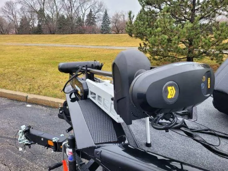 Slide: The Image of 2024 Ranger RT198P boat trailer with motor in a parking lot. - 2