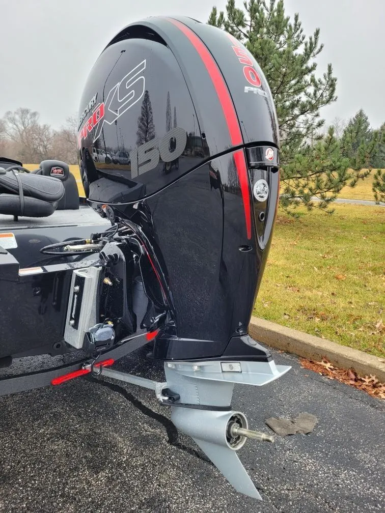 Slide: The Image of 2024 Ranger RT198P boat with a powerful outboard motor, parked on a paved surface. - 4