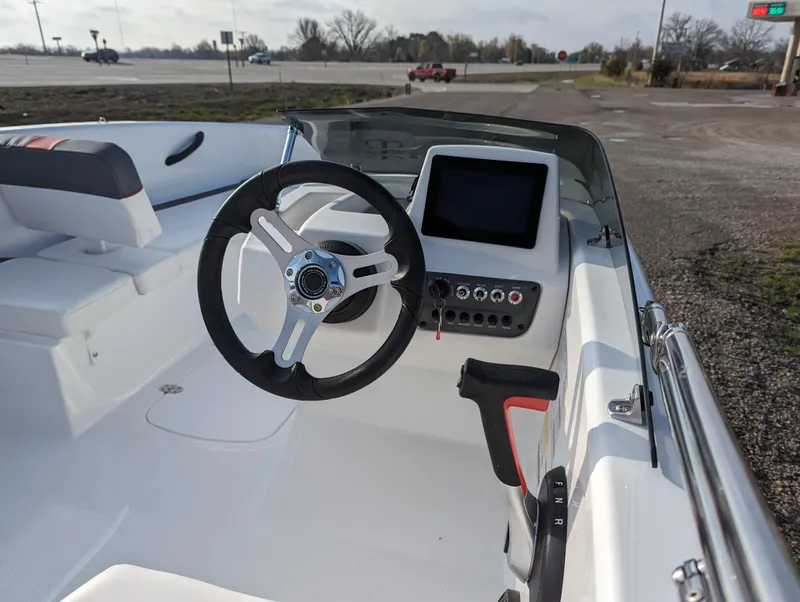 Slide: The Image of 2024 Tahoe T16 boat interior with steering wheel and control panel. - 16