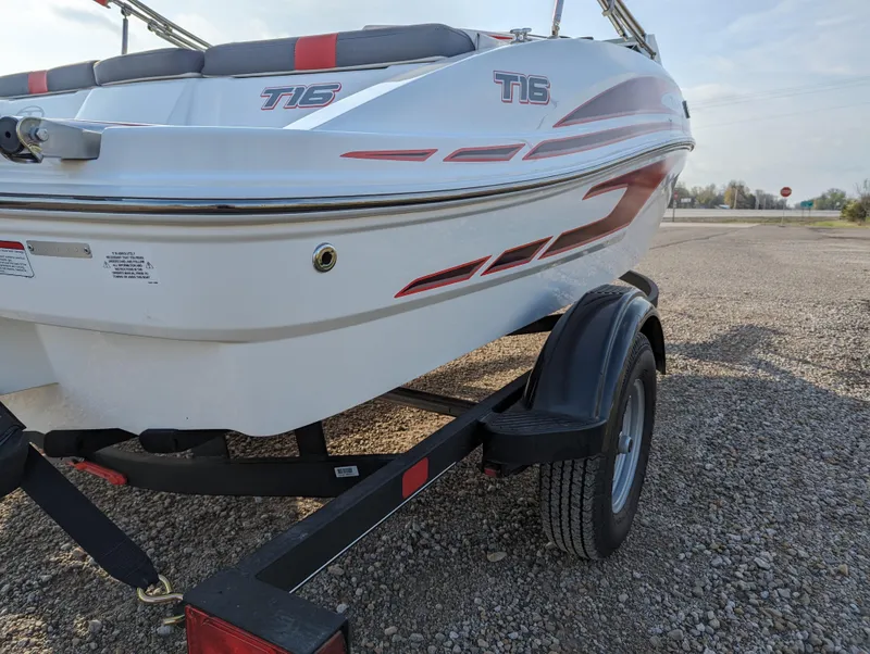 Slide: The Image of 2024 Tahoe T16 boat on trailer, rear view with red accents. - 6