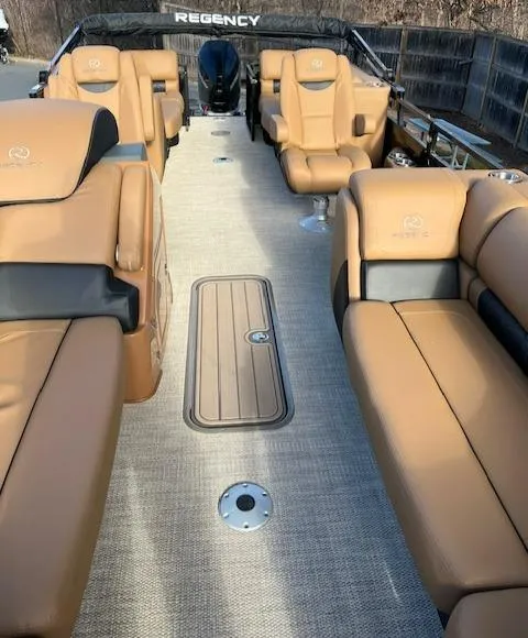 Slide: The Image of 2024 Regency 230 LE3 boat interior with luxurious tan seating and spacious layout. - 10