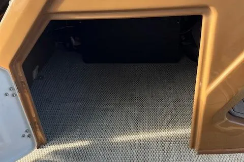 Slide: The Image of 2024 Regency 230 LE3 storage compartment with carpeted interior. - 13