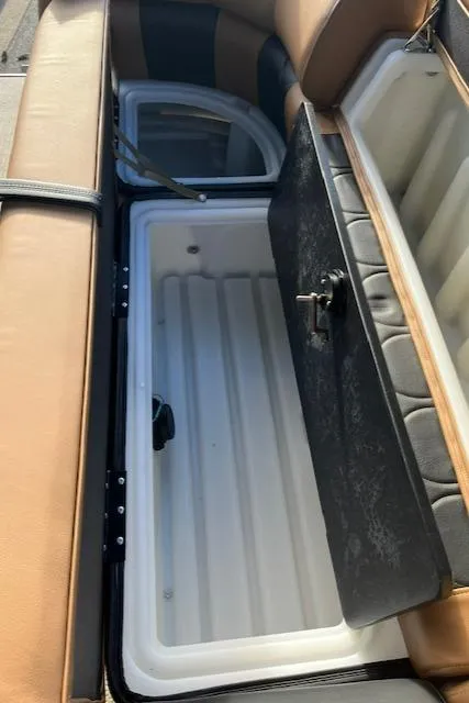 Slide: The Image of Open storage compartment in a 2024 Regency 230 LE3 boat. - 18