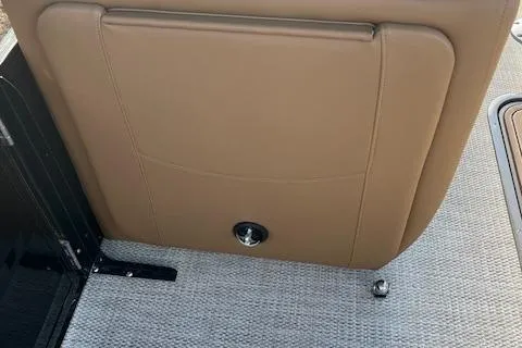 Slide: The Image of 2024 Regency 230 LE3 boat interior, tan seat back and gray carpet. - 20